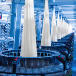 Production of white polypropylene flat yarn for the production of industrial bags. Allison-circular loom woven bag machine. Production of polypropylene sleeves. Shuttle